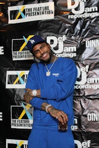 a man in a blue sweatshirt poses for a photo