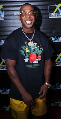 a man in a yellow t - shirt and sunglasses is smiling